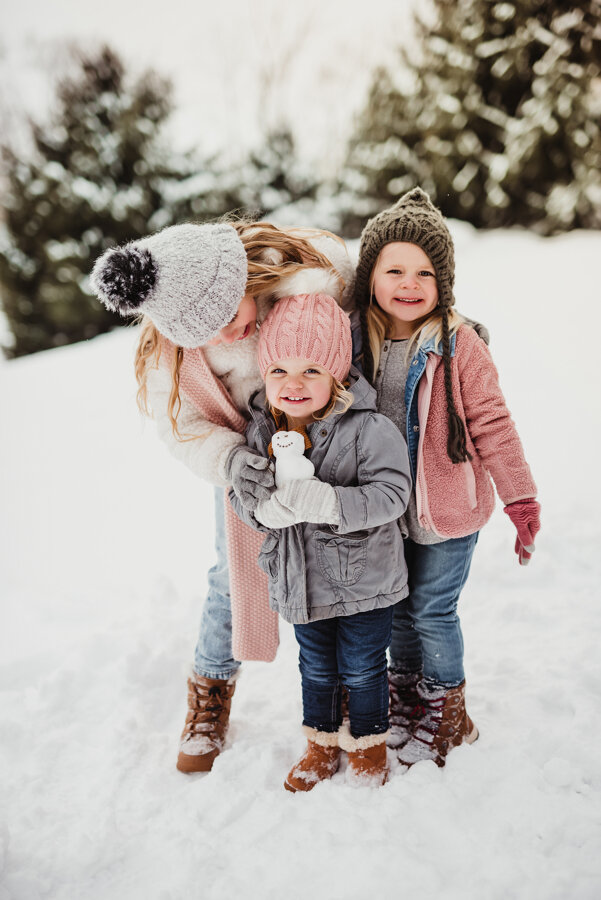 girls playing in the snow