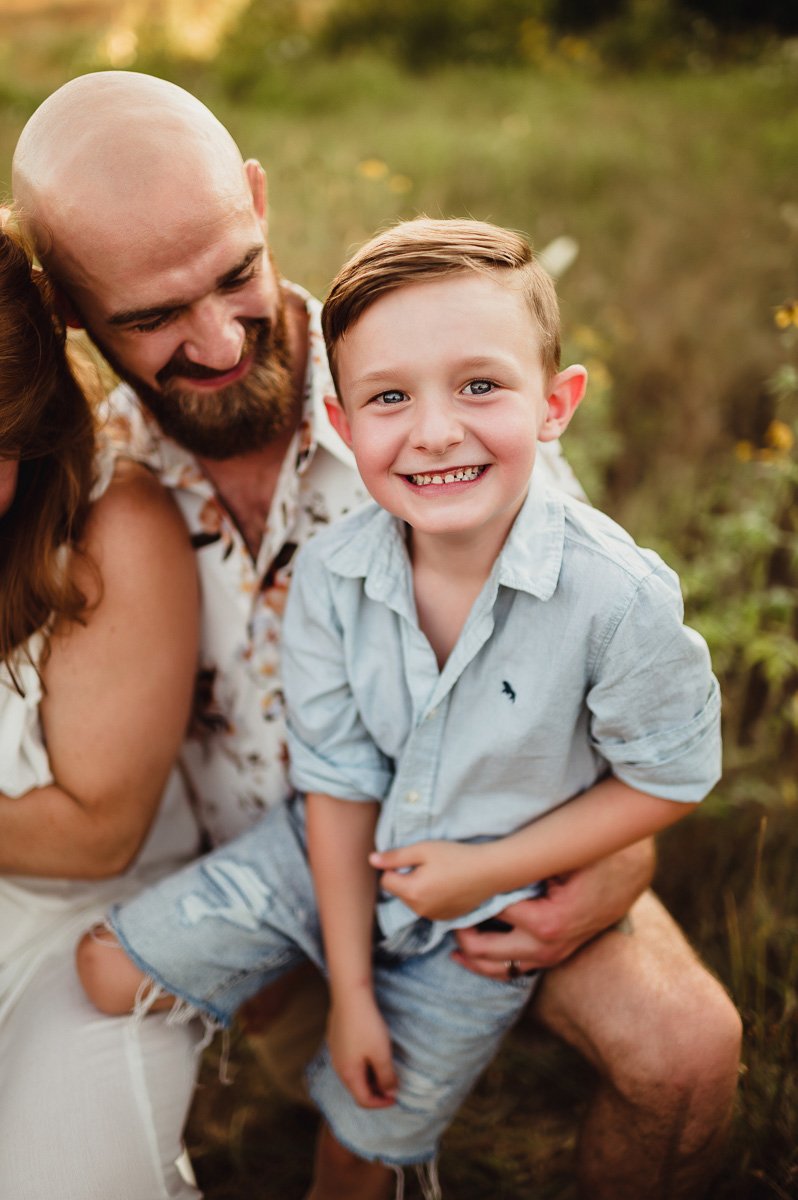 big smile from young boy in in midwest summer field