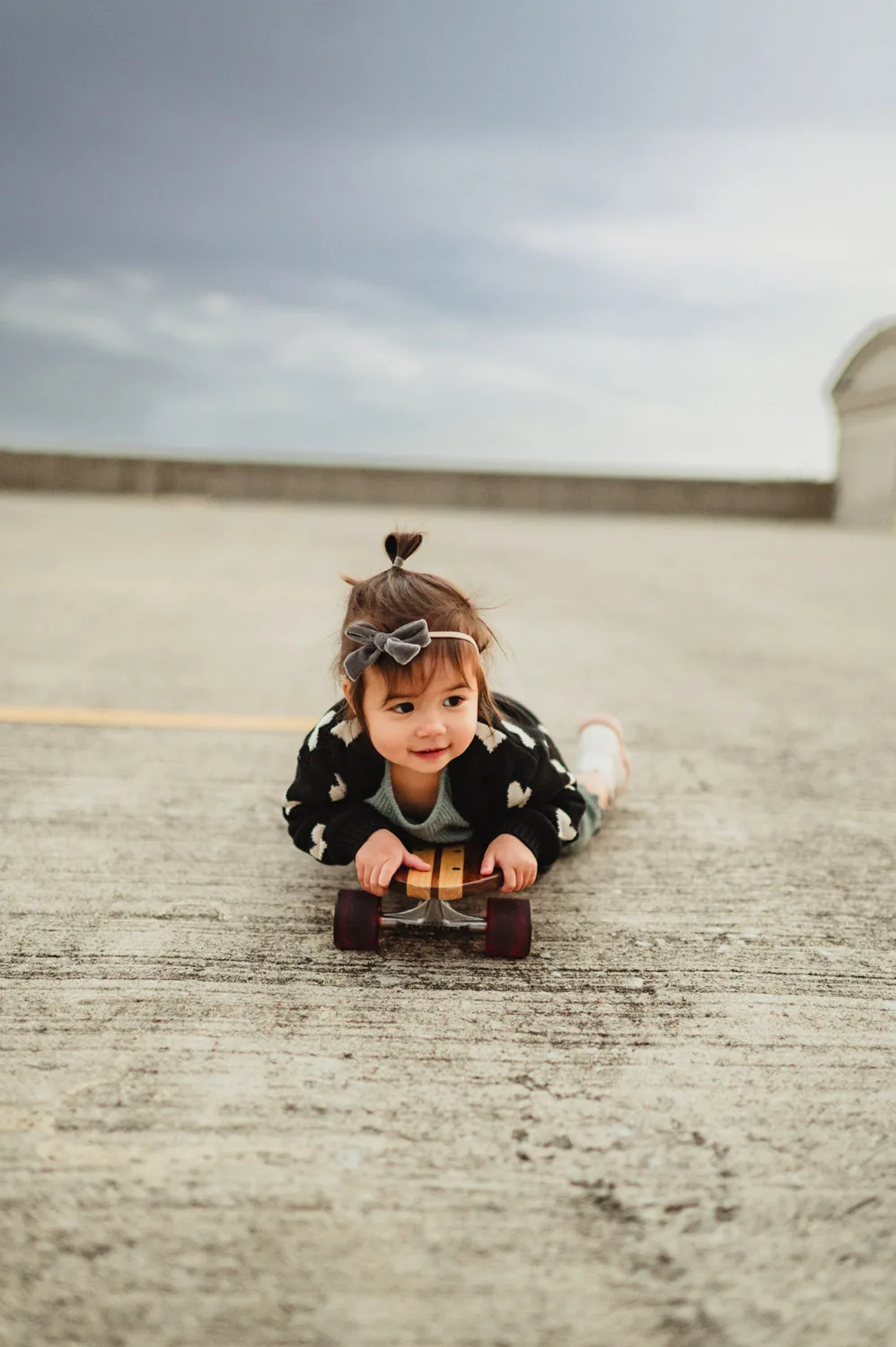 toddler laying on skateboard