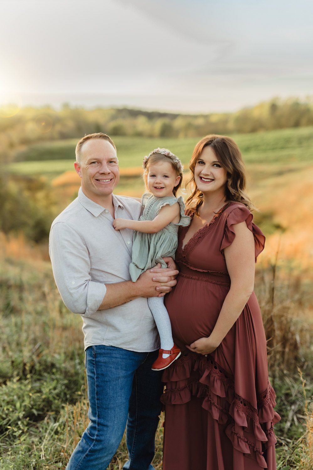 Expecting Baby #2: Golden Hour Maternity Photos in Greensboro-Greensboro maternity photos Smiling family during outdoor maternity photo session near Greensboro, NC with toddler and pregnant mother in sunset glow