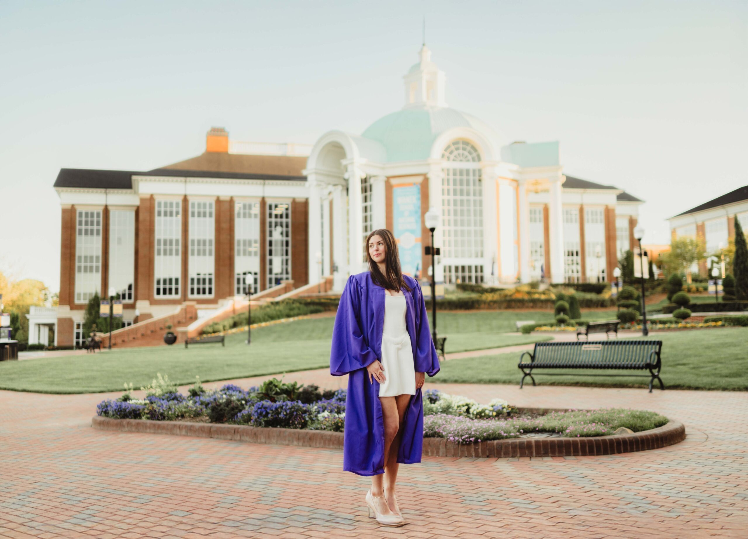 Laura's Graduation Photos at High Point University: Iconic Campus Spots + Champagne Fun-graduation photos at high point university High Point University Chemistry major in cap and gown standing outside the Wanek School of Natural Sciences for graduation photos.