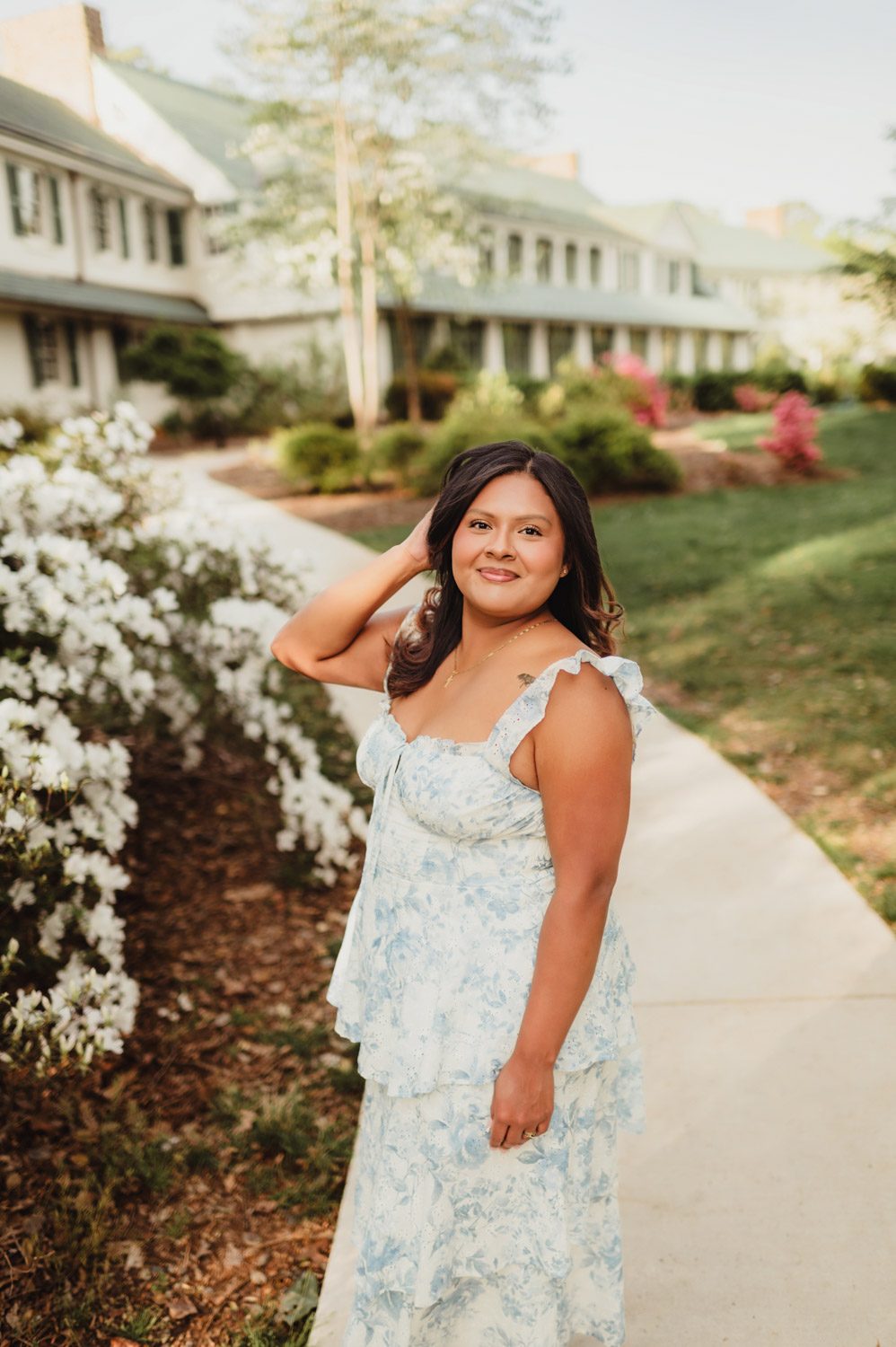 Wake Forest Graduation Photos | Celebrating Aris’s Master’s Degree-Wake Forest graduation photos Reynolda House garden photo of Wake Forest graduate in a blue floral dress during spring graduation session