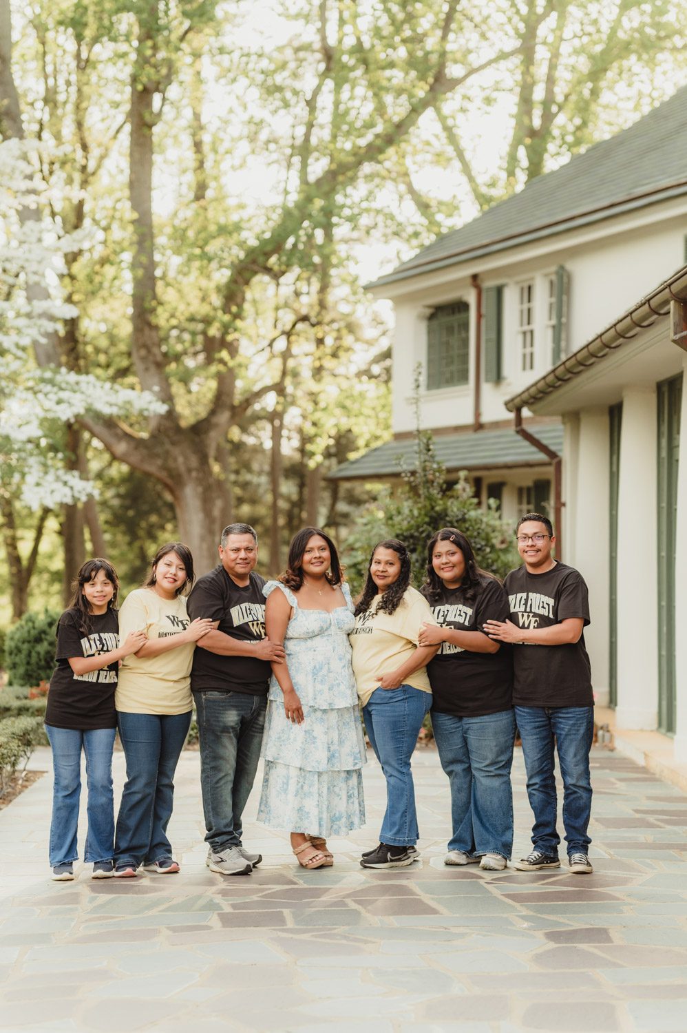 Wake Forest Graduation Photos | Celebrating Aris’s Master’s Degree-Wake Forest graduation photos Wake Forest grad session with family in matching Wake Forest shirts outside Reynolda House Museum