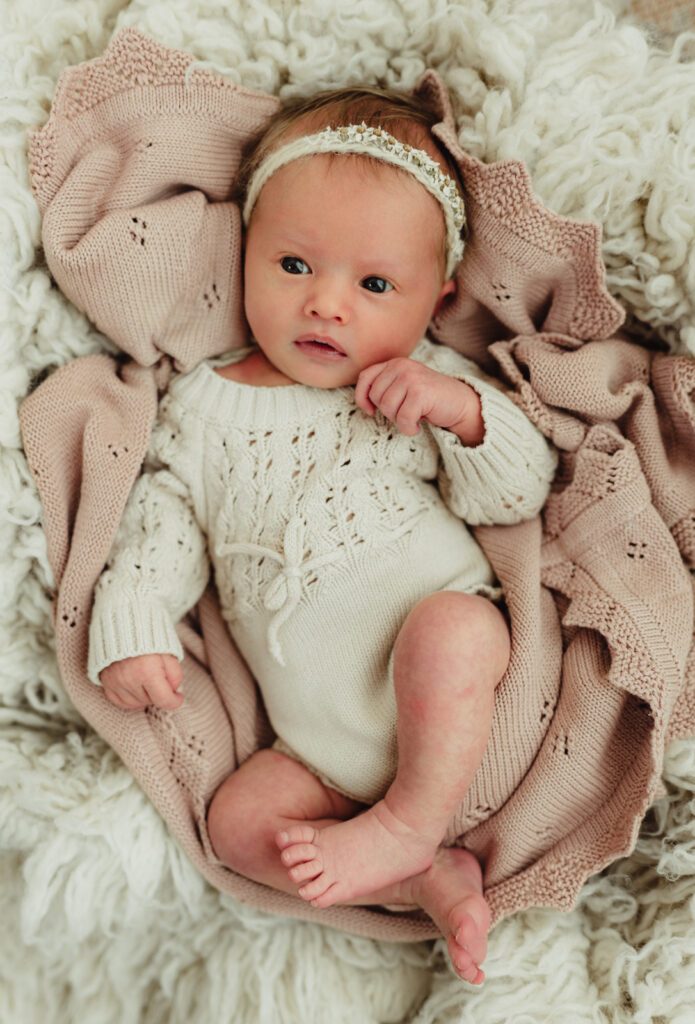 Newborn baby girl photographed awake and alert during Greensboro studio session

