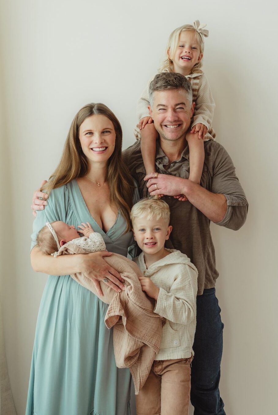 Greensboro newborn photographer captures family of five with newborn baby in studio session at Revolution Mill
