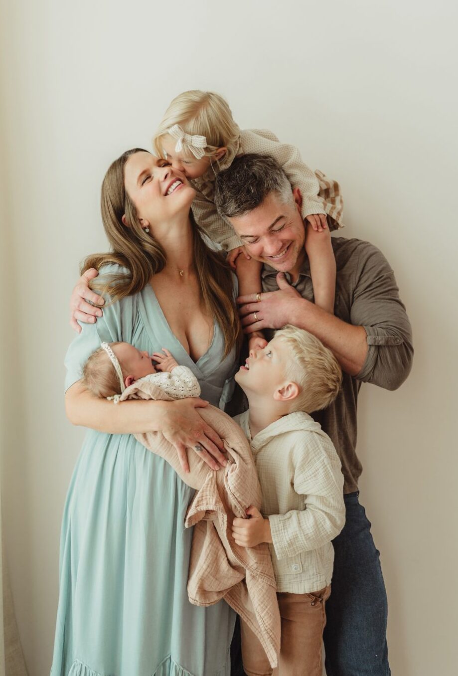 Greensboro newborn photographer captures family of five with newborn baby in studio session at Revolution Mill