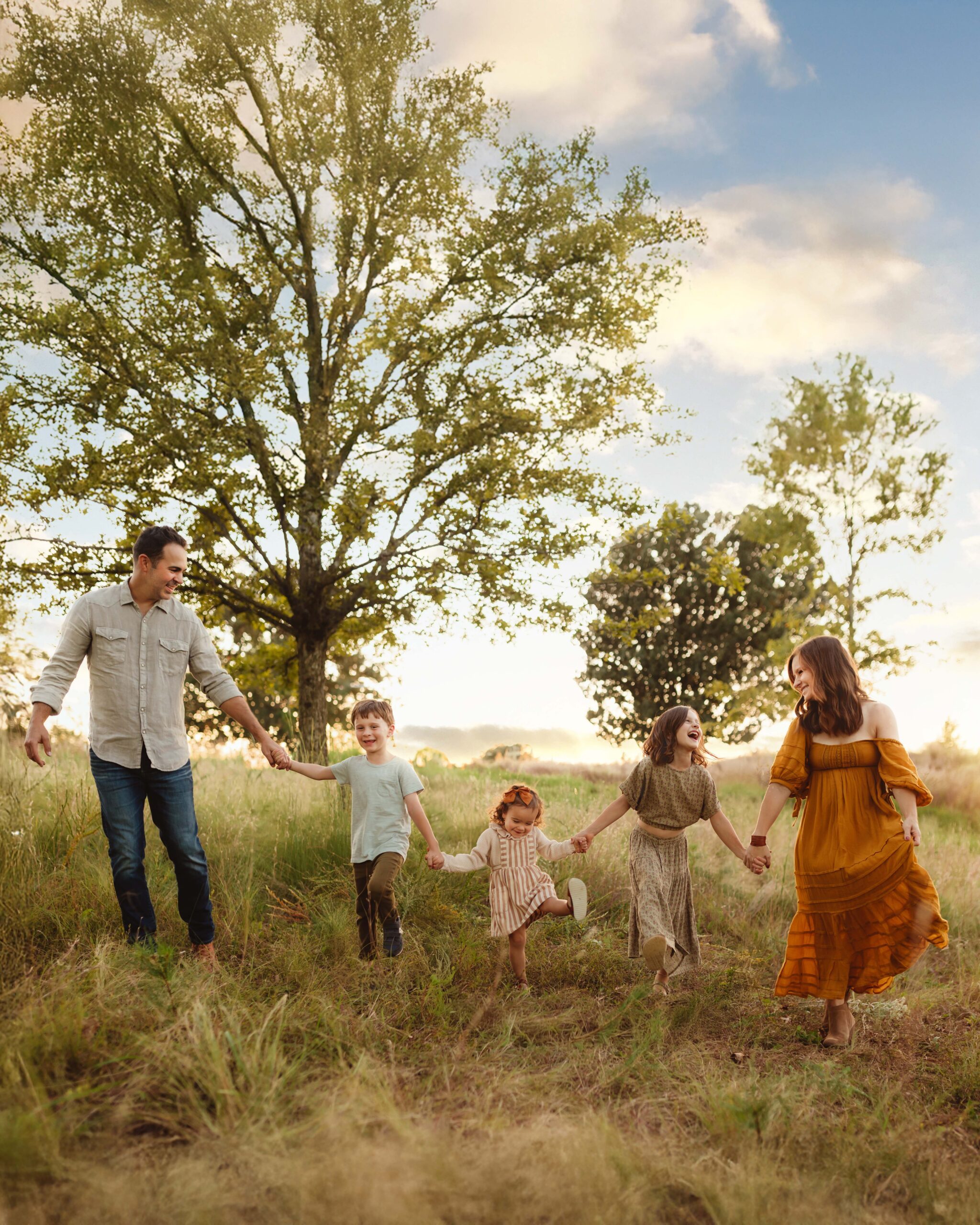Family of five holding hands and walking in a line together during a North Carolina fall family photography session. 